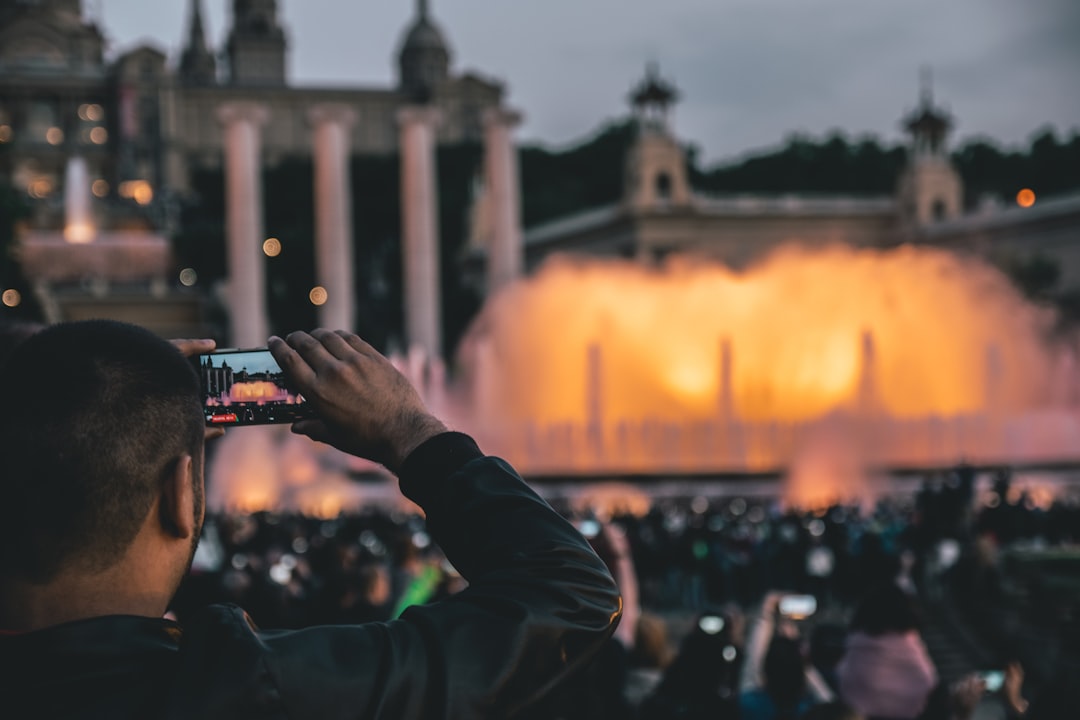 man capturing fountain at daytime