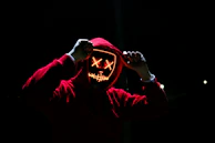 A glowing hoodie with a bold sports logo shining brightly in low light.