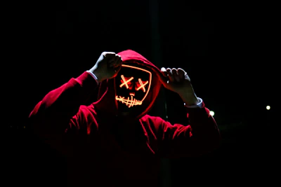 Hoodie with glowing neon accents displayed on a mannequin against a dark background