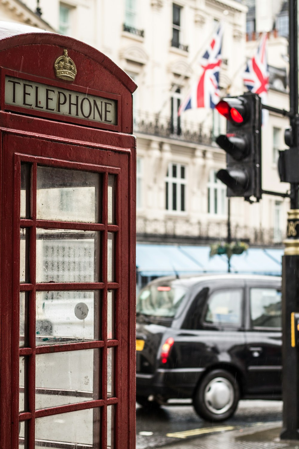 telephone booth beside a black car