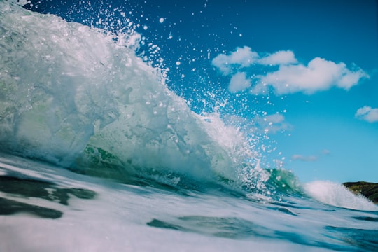 macro photography of splashing water waves in Te Arai Beach New Zealand