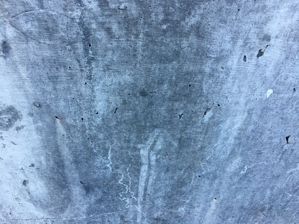 a close up of a cement wall with holes in it