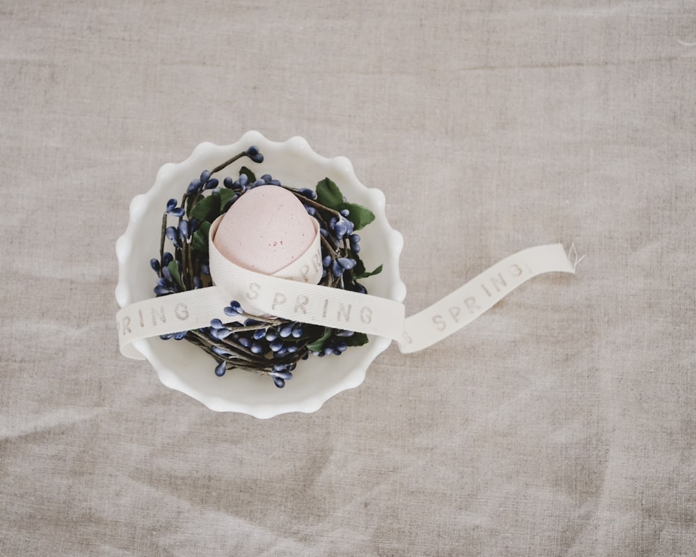 white ribbon on white plastic bowl