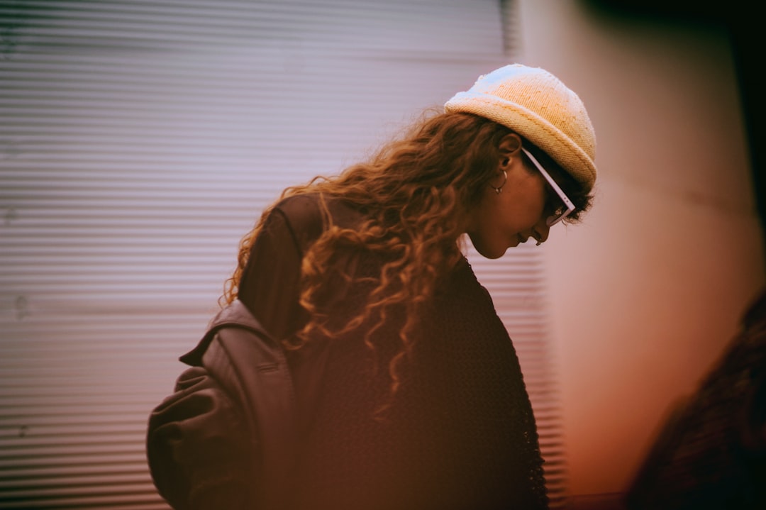 woman in black top and wearing white hat