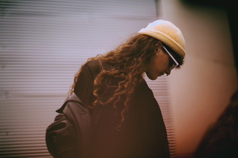 woman in black top and wearing white hat