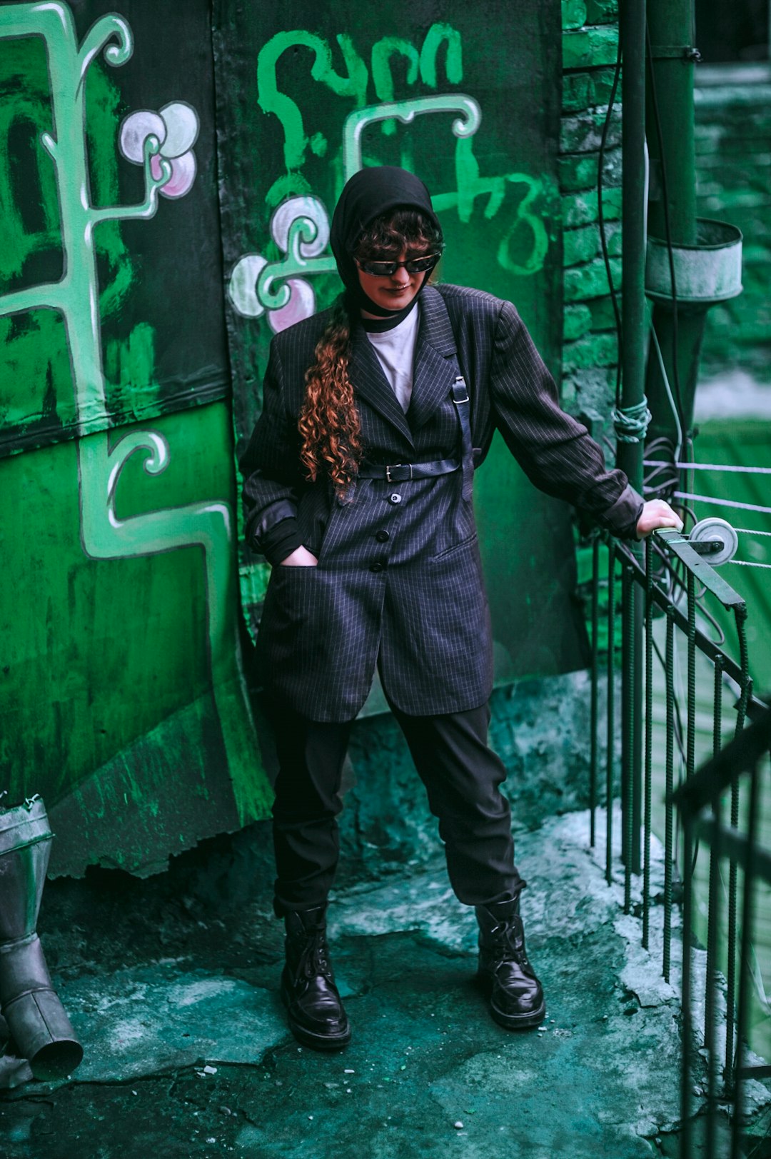 woman standing on corner holding metal rail