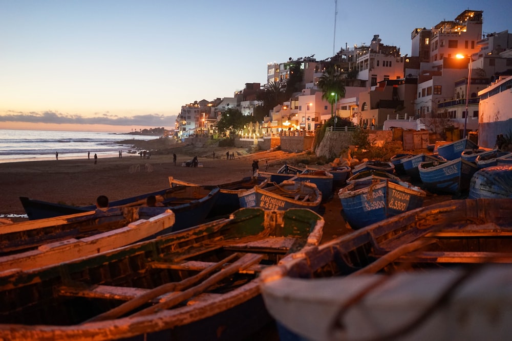 boats on seashore near houses