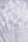 A close-up of absorbent cotton rolls stacked neatly.