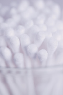 A close-up of absorbent cotton rolls stacked neatly.