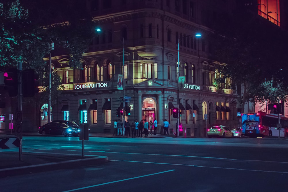 people in front of Louis Vuitton building during night