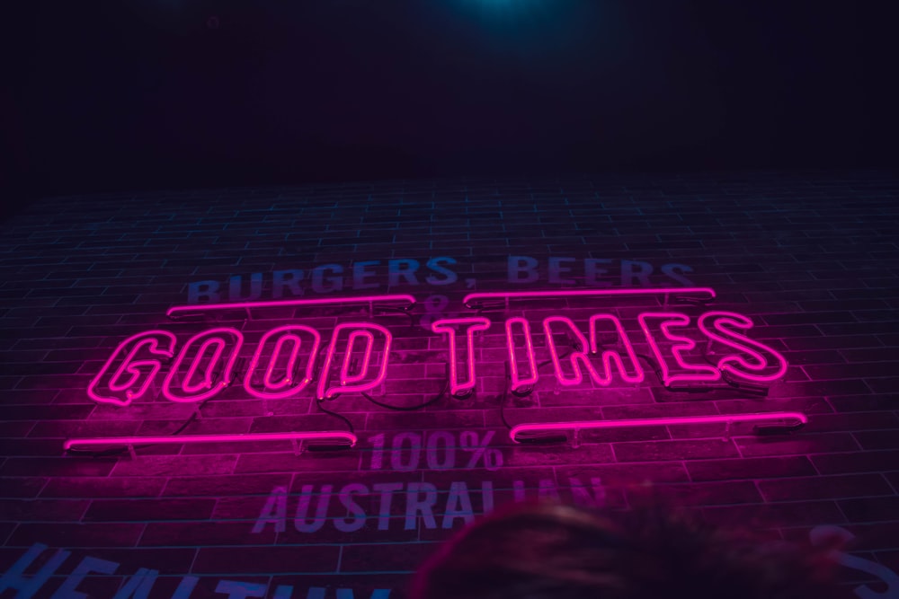 selective focus photography of pink good times neon light signage