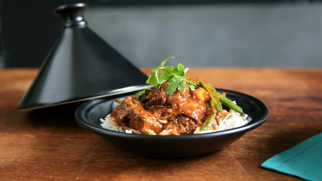 plate of fried chicken topped with green vegetable