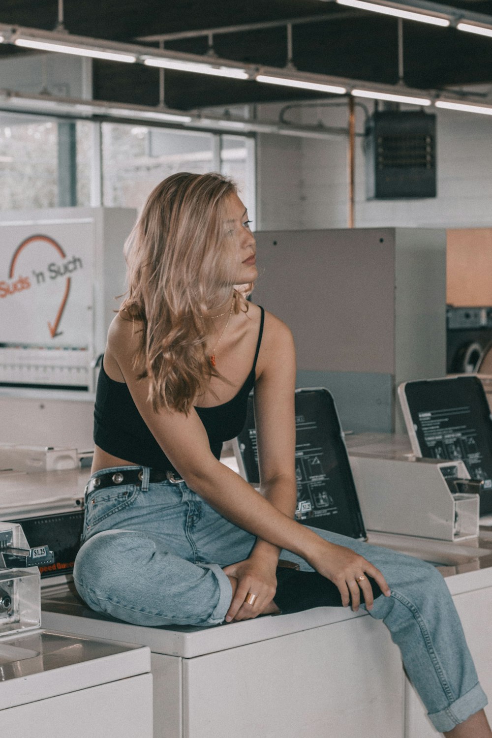 woman sitting on washer