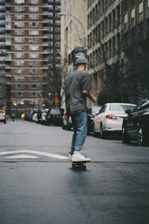 Skater cruising down a city street wearing sk8 i gr8 joggers and sneakers