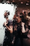 blurry reflection of light of two persons on glass window