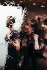 blurry reflection of light of two persons on glass window