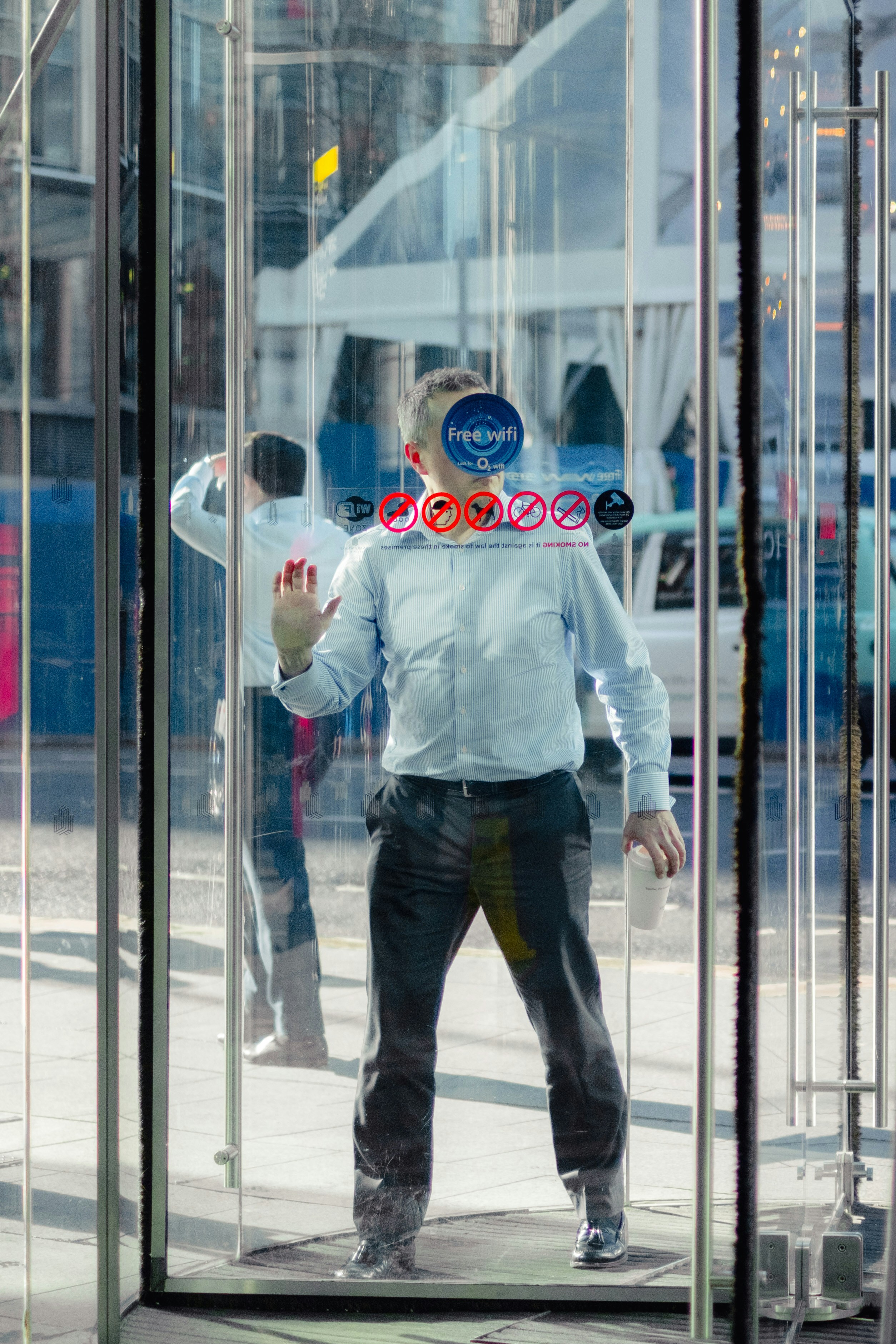 An office employee going through a revolving door