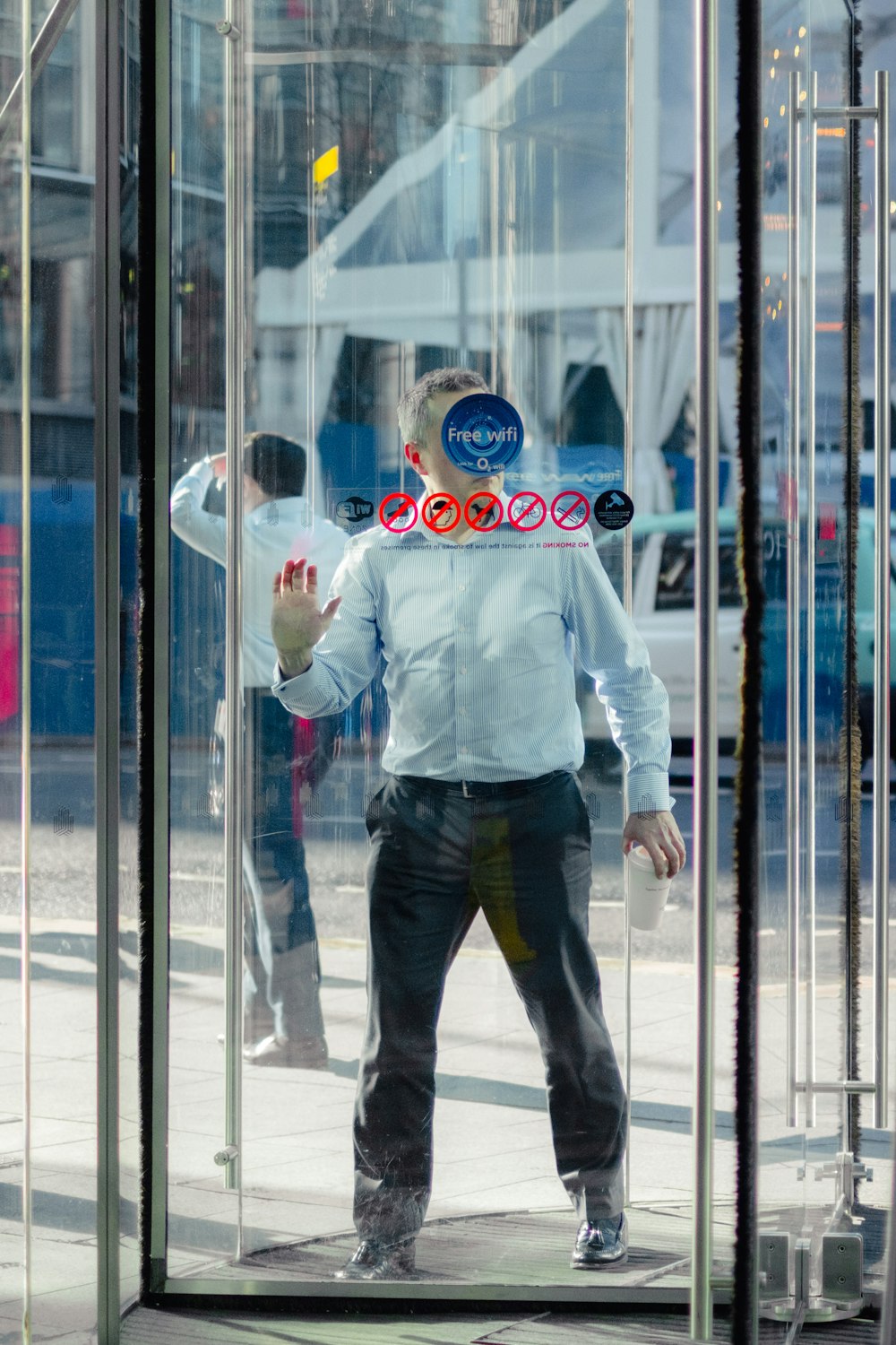 man leaning on glass door