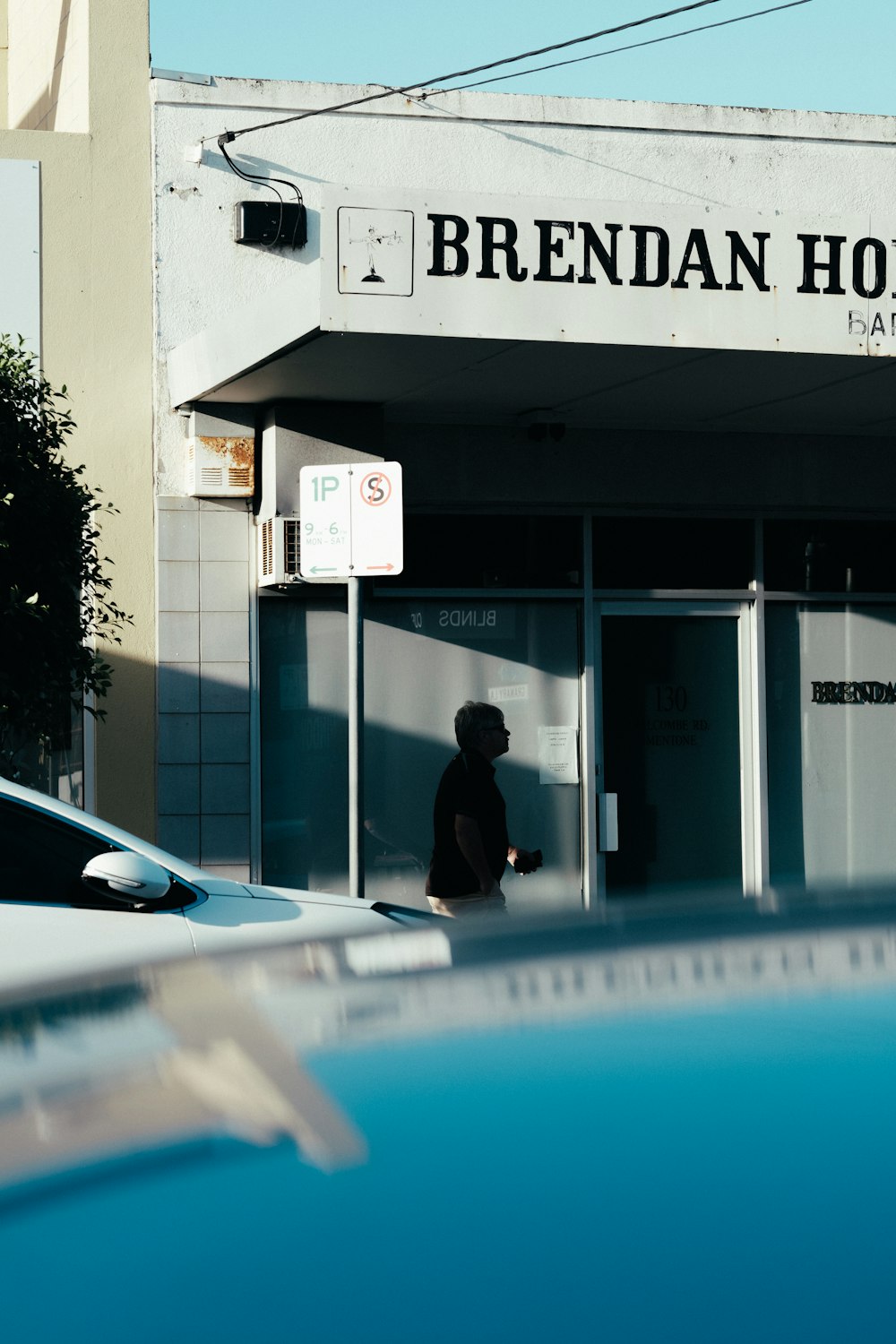 man walking beside car