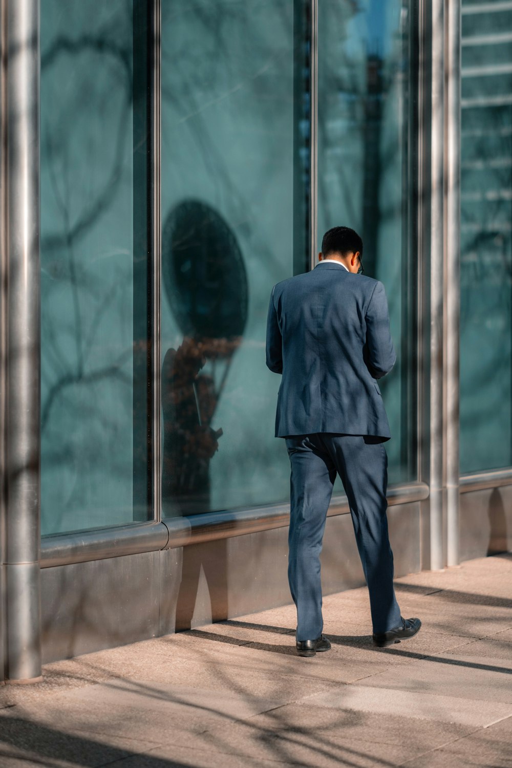 man standing near glass wall