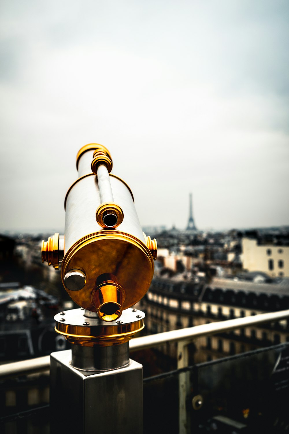 white and brass-colored coin-operated telescope near railings