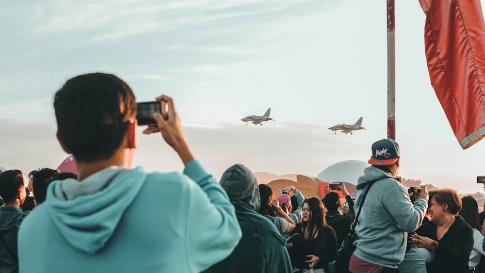 man holding camera point on planes