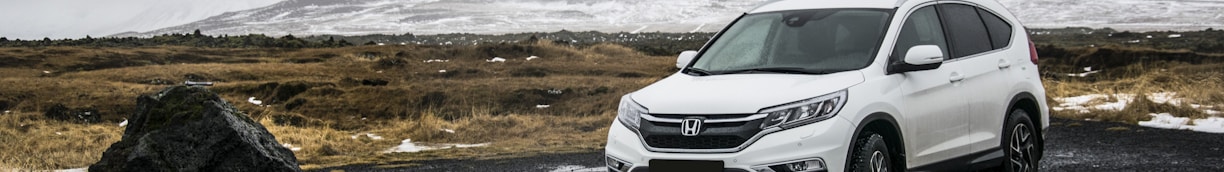 white Honda SUV on gray floor