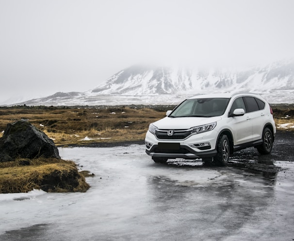 white Honda SUV on gray floor