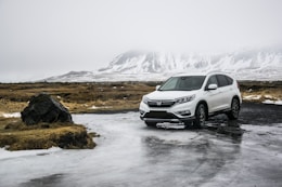 white Honda SUV on gray floor