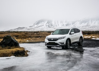 white Honda SUV on gray floor