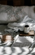 A serene morning scene with a journal, coffee, and soft sunlight.
