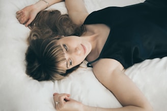 Woman lying peacefully on a bed in a sound proofed room