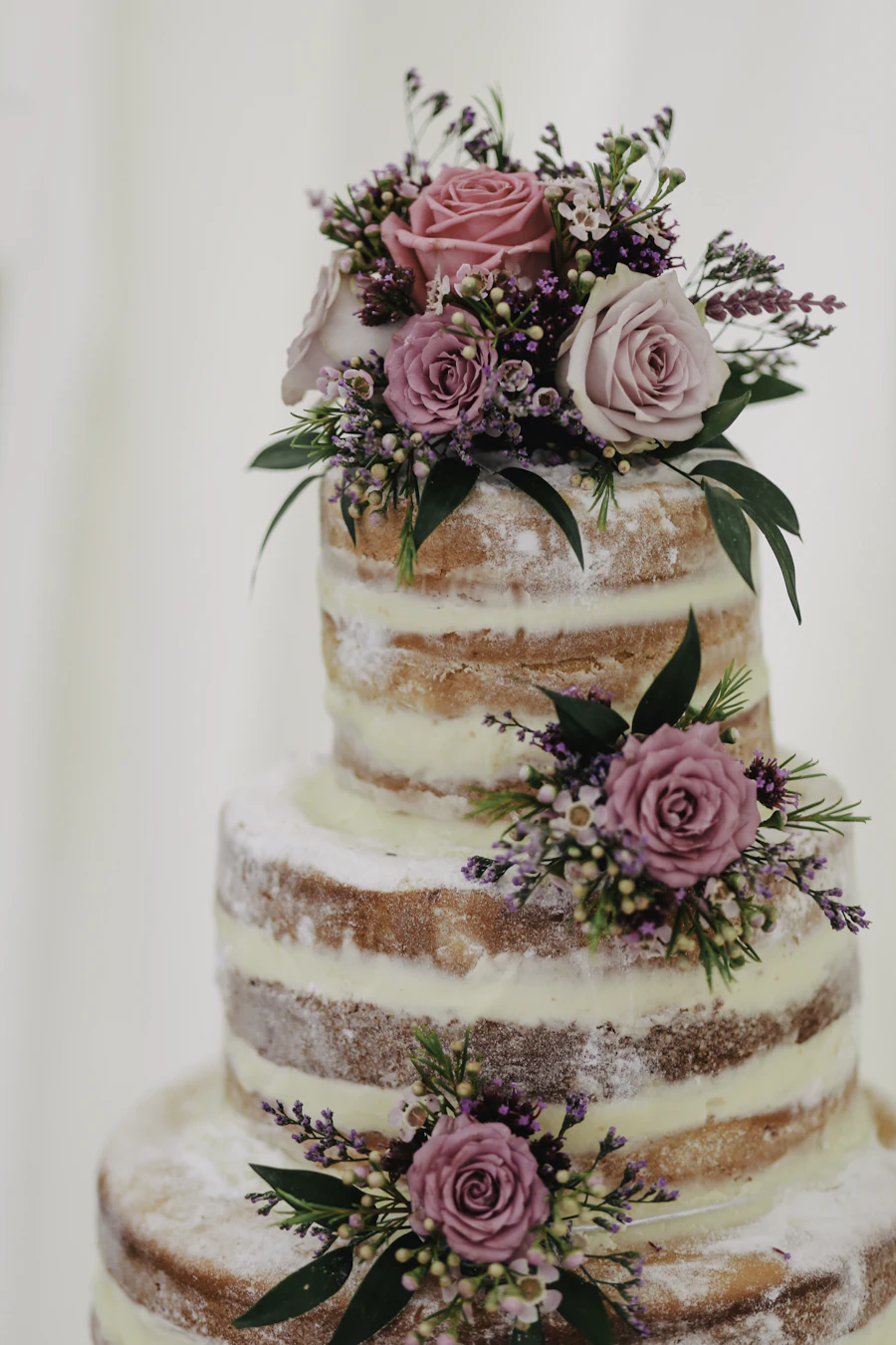 Elegant three-tier wedding cake with fresh flowers