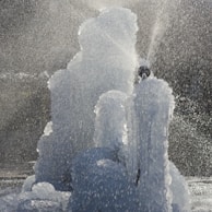 A creative water feature in a park, showing dynamic water patterns and reflections.
