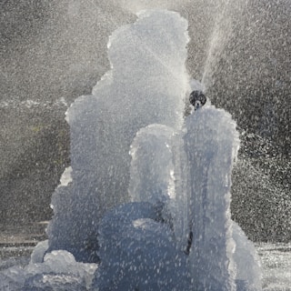A creative water feature in a park, showing dynamic water patterns and reflections.