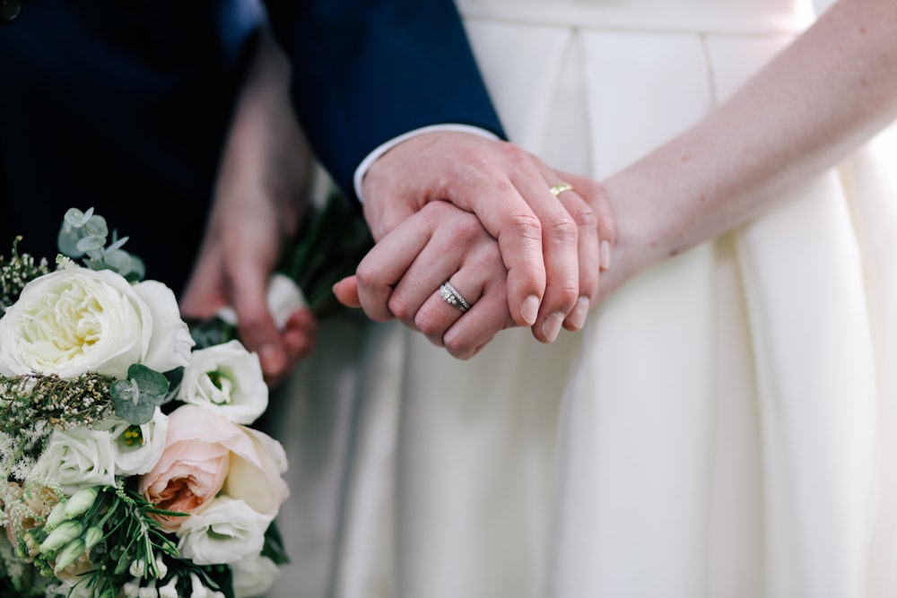 close up photo of man holding woman's hand