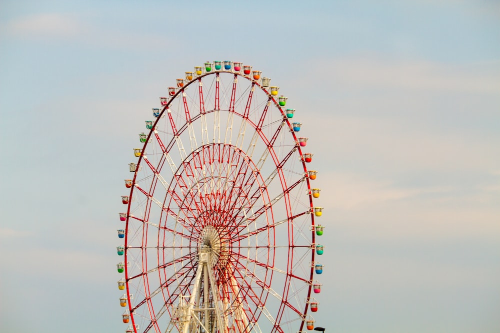 pink and yellow Ferris wheel under clear sky