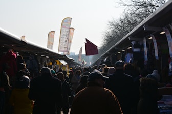 An overhead shot of a bustling outdoor market with multiple advertising banners.