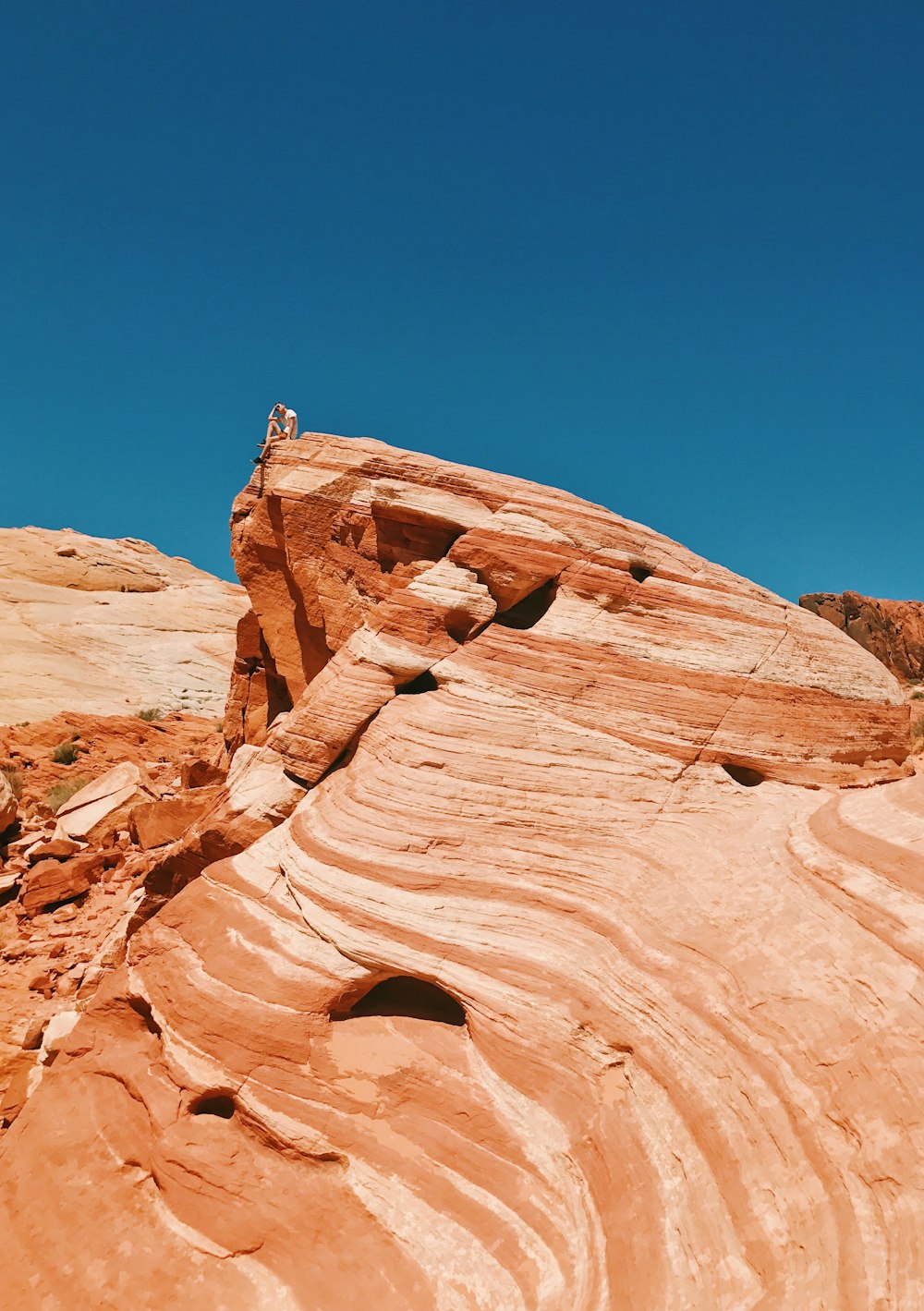 person sitting on top of rock formation