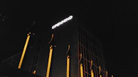 Mintiva's logo illuminated on a glass office door during evening hours.
