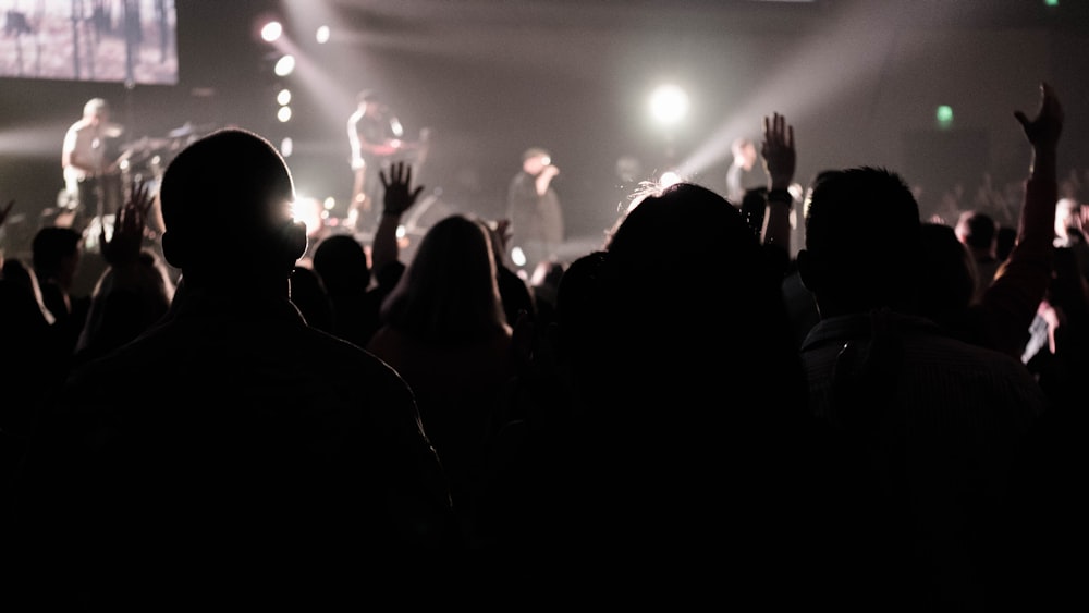 silhouette of crowd watching live band concert