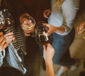 group of people tossing wine glass