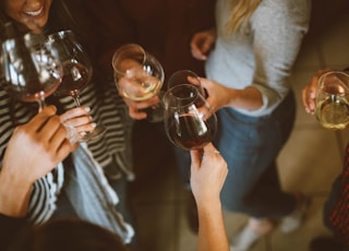 group of people tossing wine glass