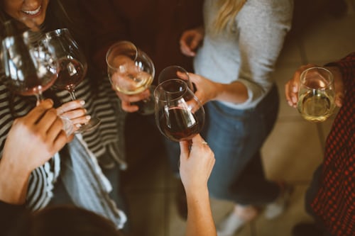 A group of friends giving a birthday toast for Instagram. 