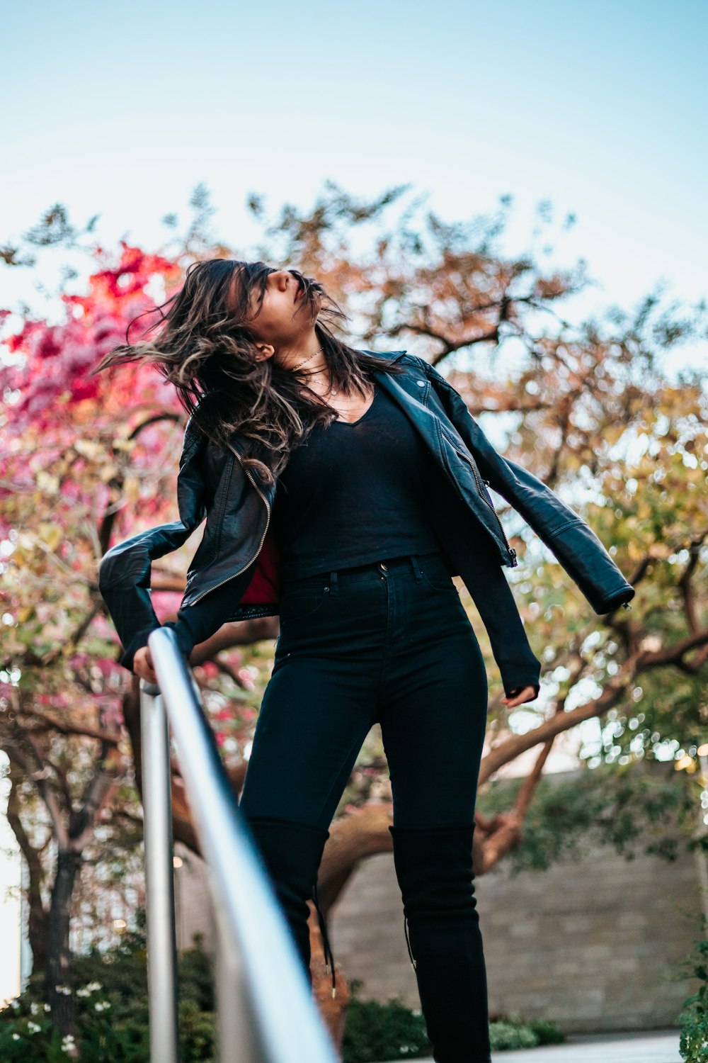 woman holding on hand rail while doing gesture in street