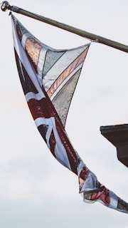 white and maroon flag on pole