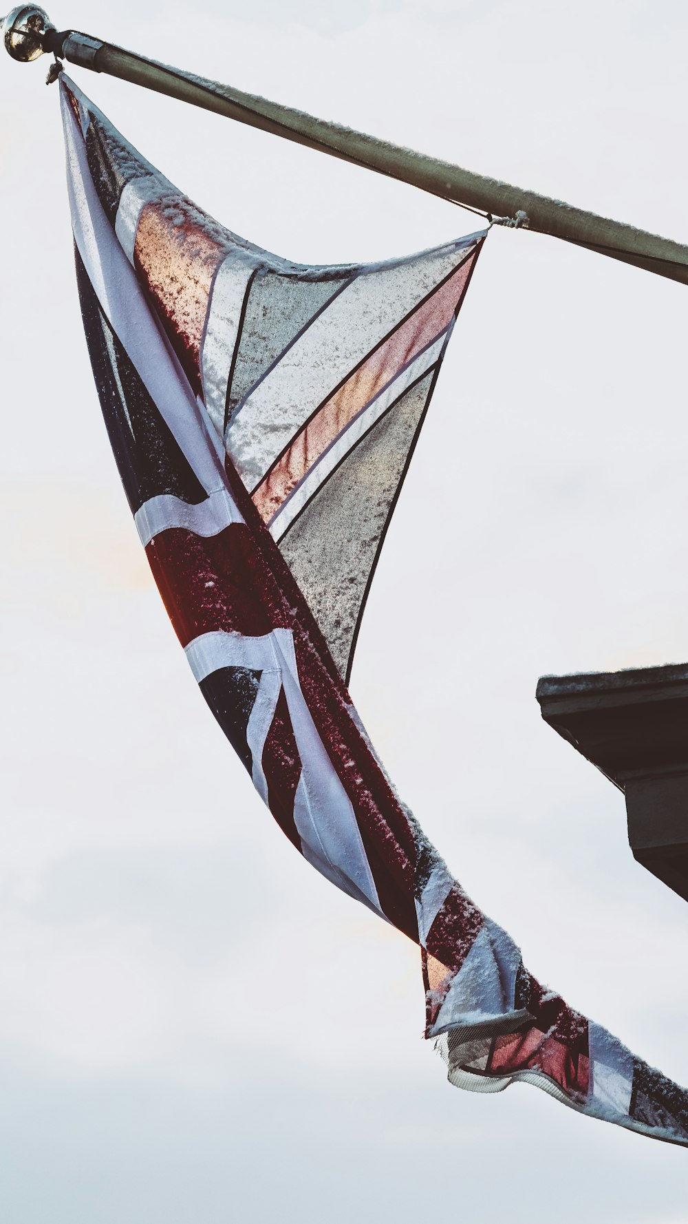 white and maroon flag on pole