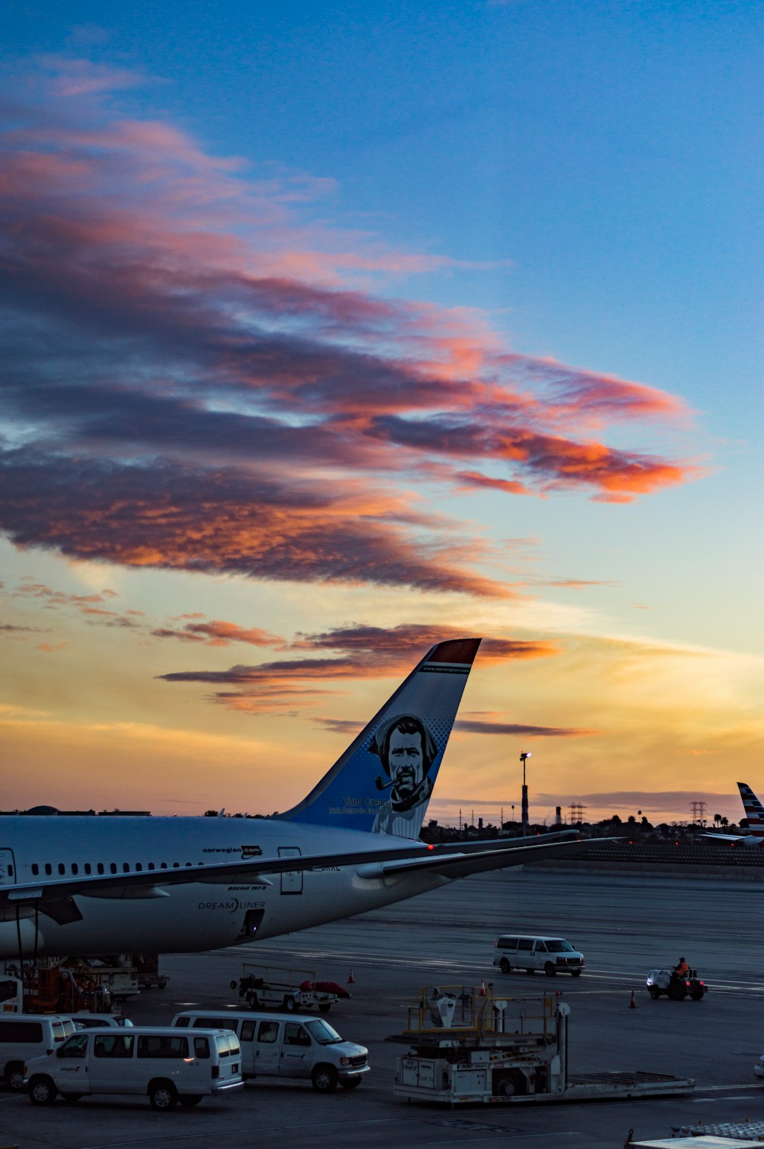 white and blue airplane during sunset