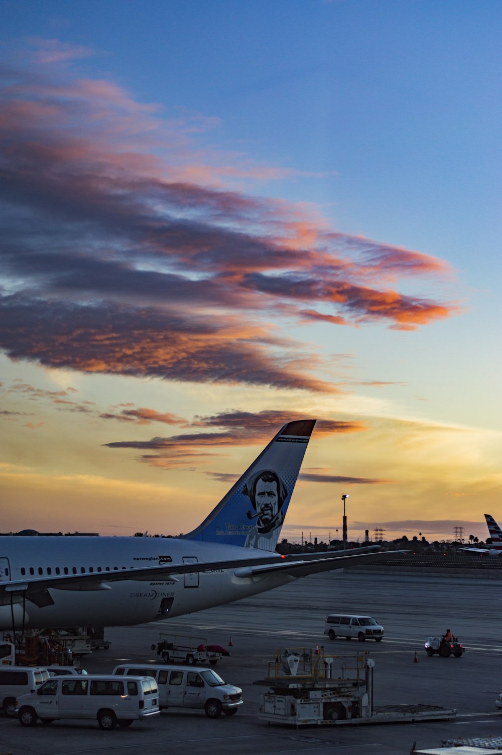 white and blue airplane during sunset