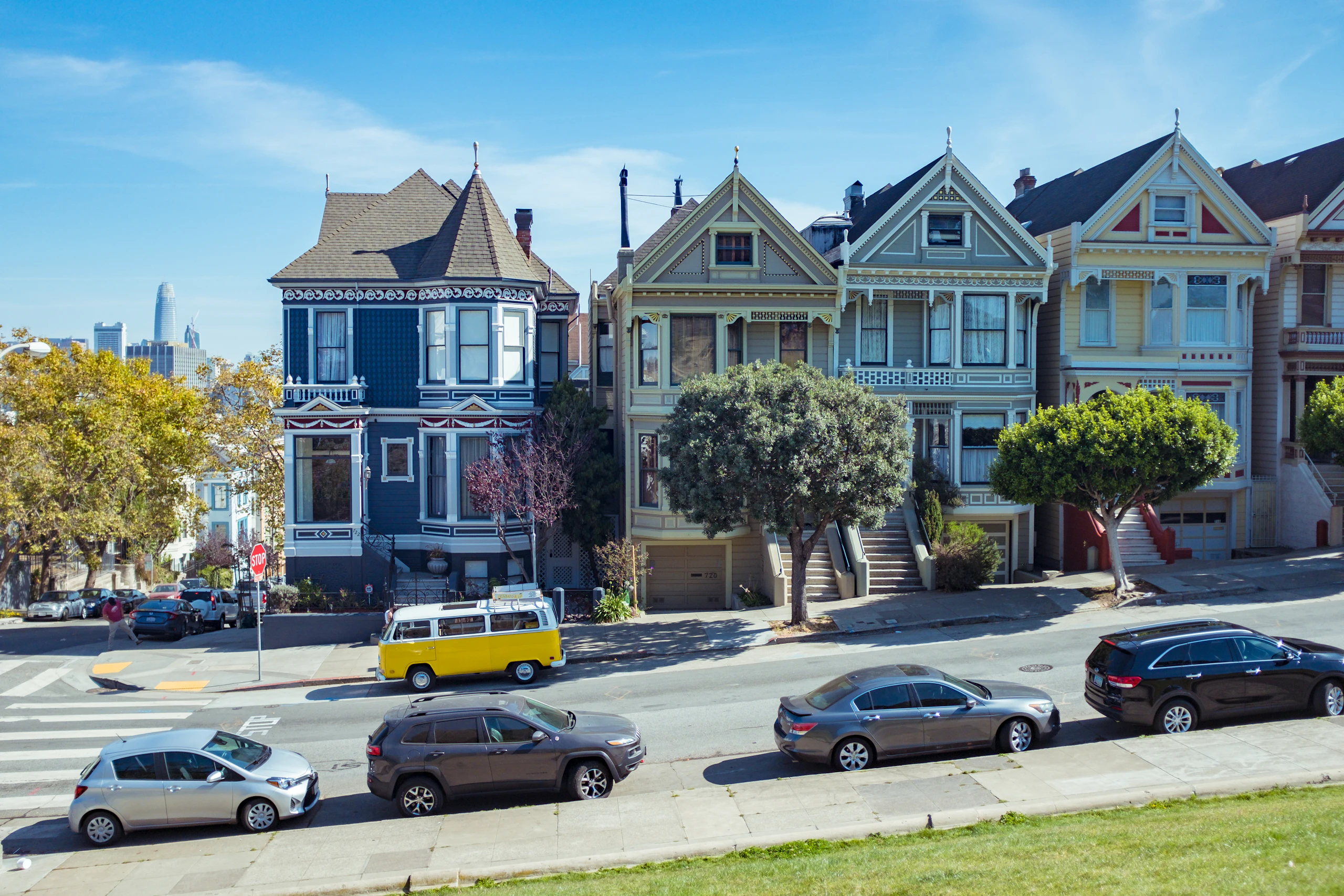 A residential San Francisco street lined with bay-windowed houses